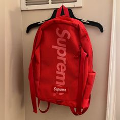 Red Supreme Backpack Brand New University Red Backpack For Everyday Use, University Red Everyday Backpack, Red Backpack For Streetwear, Sporty Red Bag For Streetwear, University Red Travel Backpack, Sporty Red Backpack For Everyday Use, Sporty Red Backpack, Red Backpack With Zipper Closure, Red Backpack For Daily Use