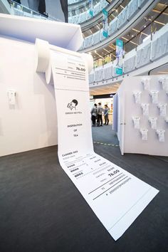 a large white piece of paper sitting on top of a floor next to a wall