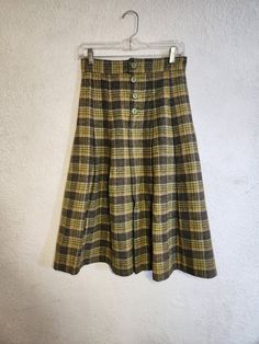 "Vintage plaid wool a-line skirt from the 1970's. Skirt is very well made and appears to be thick, heavy wool or wool blend. No size or fabric tags, so please follow the given measurements.  Skirt features a 4-button front closure and is fully lined with a soft blue underskirt. All photos should be considered part of the description.  Measurements are approximate.  Waist: 13.5\" Length: 29\"" Vintage Flared Skirt Bottoms For Fall, Retro Wool Bottoms For Fall, Vintage Lined Skirt For Fall, Vintage Flared Skirt For Fall, Fall Wide Leg Wool Skirt, Wide Leg Wool Skirt For Fall, Vintage Knee-length Bottoms For Winter, Vintage Knee-length Winter Bottoms, Retro Full Skirt Bottoms For Winter