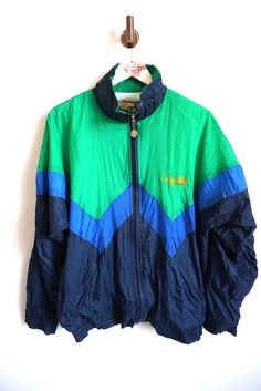 Jacket details: * Blue / Green windbreaker * Zipper on front * Condition: Perfect vintage condition Measurements, laying flat: Length: 28" / 70 cm Armpit to armpit: 25" / 63 cm Shoulder to shoulder: 26" / 65 cm sleeve: 21 1/2" / 56 cm Label size: L Feel free to message me with any questions Green Color Block Outerwear For Sports, Retro Green Outerwear For Sports, Green Retro Outerwear For Sports, Retro Green Track Jacket For Outdoors, Sports Green Color Block Outerwear, Green Color Block Track Jacket For Sports, Retro Green Track Jacket For Outdoor, Sporty Green Color Block Track Jacket, Green Retro Sports Outerwear