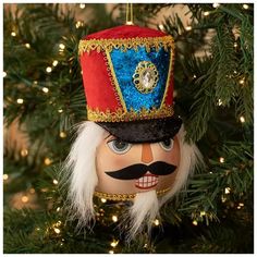 a nutcracker ornament hanging from a christmas tree