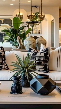 a living room filled with lots of furniture and plants on top of a white table