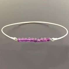 Amethyst Bead Bracelet - Amethyst Bracelet - February Birthstone Jewelry - A row of 10 faceted amethyst gemstone beads has been transformed into an elegant amethyst beaded bangle bracelet with your choice of sterling silver or 14k gold filled bangle band. Perfect for a February birthstone bracelet.This February amethyst jewelry can be personalized with an initial dangle. Simply add to cart to make a customized amethyst beaded bracelet;http://www.etsy.com/listing/84670605/add-an-initial-charm-to- Purple Beaded Birthstone Bracelets As Gift, Purple Beaded Birthstone Bracelets For Gift, Purple Birthstone Beaded Bracelets As Gift, Purple Birthstone Beaded Bracelets For Gift, Spiritual Amethyst Beaded Birthstone Bracelet, Hand-strung Silver Amethyst Jewelry, Adjustable Amethyst Beaded Bracelets With Birthstone, Purple Amethyst Birthstone Bracelet, Adjustable Amethyst Bangle Jewelry