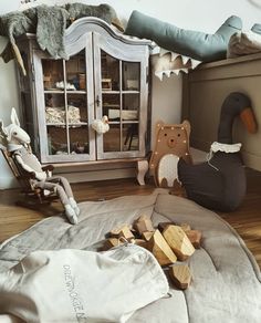 a child's room with stuffed animals and toys on the floor in front of it