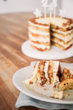 a piece of cake sitting on top of a white plate next to a slice of cake