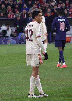 two soccer players are standing on the field