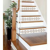 the stairs are painted white and brown with floral designs on them, along with a potted plant