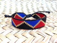 Mountain View red, blue, black and gold beaded bracelet was 100% handwoven on a loom with smaller size 15 seed beads.  One-of-a-kind unique piece for men, women or children. 15cm - expandable for larger wrist sizes 1.3 cm wide Bracelets Hippie, Friendship Bracelets With Beads, Medicine Wheel, Hippie Bracelets, Gold Bead Bracelets, Hat Band, Gold Beads, Friendship Bracelets, Hippie Boho