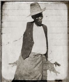 an old black and white photo of a man wearing a hat with his hands in his pockets