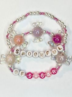 a bracelet with beads and charms that say poopupple on it's side