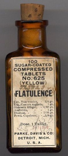 an old medicine bottle is hanging on the wall in front of a gray background that says, sugar - coated compressed tables yellow flatulence