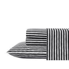 two black and white striped sheets on top of each other, one is folded up