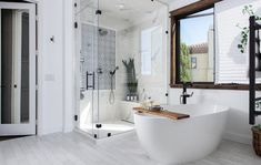 a bathroom with a tub, sink and window