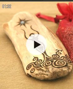 a wooden object with an intricate design on it and a red bag next to it