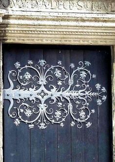 an ornate metal door on the side of a building