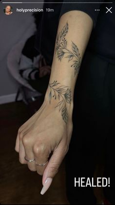 a woman's hand with a tattoo on it and the words healed above her