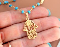 "This is a gorgeous multi-strand necklace made of 3mm faceted Turquoise gemstones on 24kt gold veril. Necklace layers measure 16\"-18\" or 18-20\" with a 18kt gold filled Hamsa pendant that measures 3/4\". Beautiful gold rose beads accent this lovely necklace. Necklace comes nicely boxed for the perfect gift! Turquoise absorbs negativity, promotes honest & clear communication from the heart & is an excellent grounding stone. Good for healing the spirit & soul, it is known as a master Multi Strand Necklaces, Multi Strand Necklace Gold, Hamsa Pendant, Hamsa Necklace, Protection Amulet, Necklaces Gold, Hand Of Fatima, 24kt Gold, Lovely Necklace