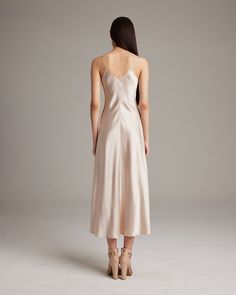 This elegant bias-cut slip dress features a spaghetti strap and flattering V Neck for a fresh, yet refined look. This perfect basic can be worn for life, dressed up, or dressed down, for the perfect effortless ensemble. 100% Silk Charmeuse Made in New York City Product Care: Dry Clean Only Formal Solid Color Summer Slip Dress, Sleek Solid Color Slip Dress For Formal Occasions, Sleek Solid Color Formal Slip Dress, Chic Cami Slip Dress For Brunch, Formal V-neck Slip Dress With Delicate Straps, Sleek Slip Dress With Bias Cut And Spaghetti Straps, Chic Fitted Slip Dress With Subtle Sheen, Chic Slip Dress With Subtle Sheen For Evening, Classic Sleeveless Slip Dress For Formal Occasions