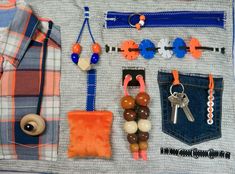 an assortment of items is displayed on a piece of cloth with buttons, beads and key chains