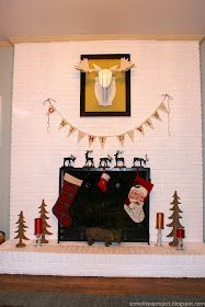 a fireplace decorated for christmas with stockings and decorations