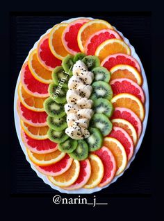 a plate filled with sliced fruit and kiwis