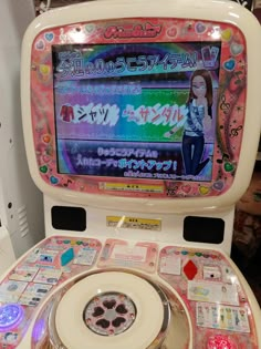 an old fashioned video game sitting on top of a white machine with lots of stickers