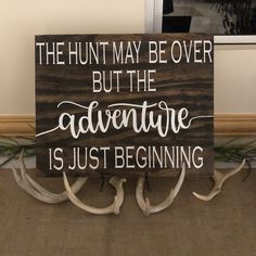 a wooden sign that says the hunt may be over but the adventure is just beginning