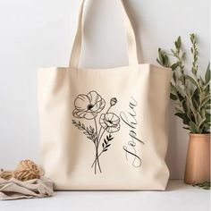 a tote bag sitting on top of a table next to a potted plant