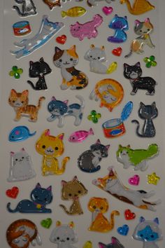 many different types of cat magnets on a white surface