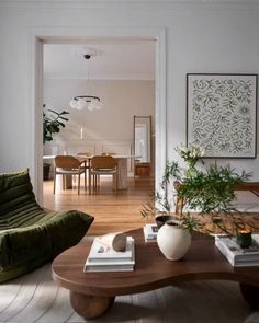 a living room filled with furniture and a wooden table