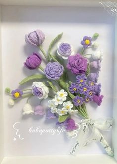 crocheted flowers in a white box with ribbon