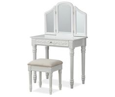 a white dressing table with mirror and stool