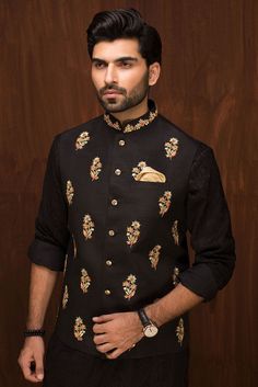 Elevate your style with a classic black raw silk waistcoat, paired seamlessly with a matching kurta and pajama. Perfect for traditional events, weddings, or any cultural occasion, enhancing your ensemble with timeless elegance.Exuding an aura of sophistication, the black raw silk waistcoat steals the spotlight with its intricate embroidery adorning the collar and delicate floral motifs scattered across the front. Complementing this masterpiece is a matching black embroidered fabric kurta and a p Party Dress Pakistani, Indian Wedding Reception Outfits, Marriage Gown, Wedding Reception Outfit, Reception Outfits, Dresses Pakistani, Wedding Kurta For Men, Dress Pakistani, Wedding Dresses Men Indian