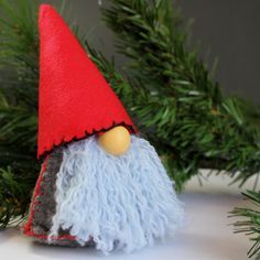 a close up of a gnome's hat on a christmas tree ornament