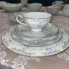 a table topped with white and blue dishes