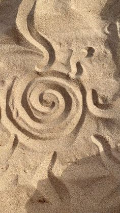 the sand has swirls in it and is made into a spiral design on top