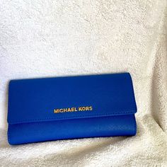 Mk Wallet Bag Nwt Never Used (Check Closet For Matching Tote Bag)!!! Whether It's A Trip To Rome Or The Corner Store, This Jet Set Wallet From Michael Michael Kors Works Any Look You Like. Luxe Saffiano Leather Is Fronted By Gilded Logo Lettering, While The Organized Interior Keeps Your Financials In Check. (Send Me A Offer!!) Michael Michael Kors Wallet Saffiano Leather Magnetic Snap Closure Gold-Tone Hardware; Back Zip Pocket; Logo Plaque At Front Interior Features Bill Compartment And 8 Card Classic Blue Clutch For Travel, Classic Blue Travel Clutch, Travel Blue Clutch, Michael Kors Travel Wallet Clutch, Michael Kors Clutch Wallet With Removable Pouch, Everyday Michael Kors Rectangular Clutch, Michael Kors Rectangular Everyday Clutch, Michael Kors Clutch Wallet For Daily Use, Michael Kors Rectangular Clutch For Travel