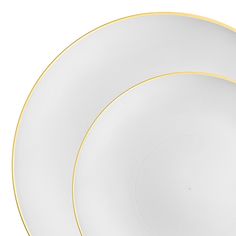 two white plates with gold trim on each one and an empty plate in the middle