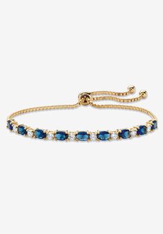 Color the day with classic style and vibrant color with this beautiful slider bracelet. Glimmering simulated blue sapphires and sparkling cubic zirconia ovals alternate on the adjustable bolo strand featuring ball ends that dangle in cool style. 6.20 carats T.W. 10" length. Richly plated in 14k yellow gold.14k Gold-PlatedMain Stone: 9 Oval Faceted Cut Simulated Blue Sapphires, 5.40 carats total weight, 6 mm x 4 mm8 Round Brilliant Cut Cubic Zirconias, .80 carat total weight, 3 mm x 3 mmDimension Gold And Blue Bracelet, Blue And Gold Bracelets, Adjustable Sapphire Bracelets For Formal Events, Adjustable Sapphire Bracelets For Formal Occasions, Adjustable Blue Round Tennis Bracelet, Adjustable Blue Tennis Bracelet, Gold And Blue Jewelry, Blue Wedding Bracelet, Blue And Gold Jewelry