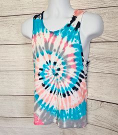 This is a tie-dye tank top. Gender neutral adult  Size small Spiral tie-dye design with coral/ pink, turquoise, grey and black. 100% cotton  See photos for size chart. Spring Tie Dye Tank Top, Spring Tie Dye Cotton Tank Top, Trendy Summer Tie Dye Tank Top, Trendy Tie Dye Sleeveless Tank Top, Casual Pink Tank Top For Festival, Casual Pink Festival Tank Top, Tie Dye Tank Top For Summer, Casual Hand Dyed Tank Top For Summer, Casual Hand-dyed Tank Top For Summer