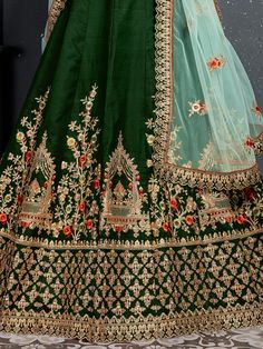 Look gorgeous in this bottle green taffeta satin silk bridal lehenga for woman decked with intricate Thread, Dori, Zari Embroidery with stone work.
Also comes with a matching color taffeta satin silk embroidered choli and mint green net embellished dupatta with similar work lace details. Green Lehenga With Dori Work, Green Meenakari Saree For Reception, Designer Green Choli With Intricate Embroidery, Green Semi-stitched Meenakari Choli, Green Lehenga With Resham Embroidery For Festivals, Green Raw Silk Lehenga For Reception, Semi-stitched Green Choli For Eid, Designer Green Lehenga For Diwali, Designer Wear Green Lehenga For Diwali