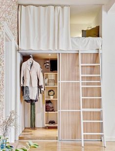 an open closet with clothes and shoes on shelves next to a ladder that leads up to the second floor