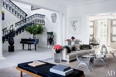 a living room filled with furniture and a staircase