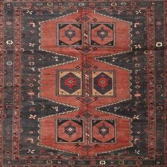 an antique rug with red and black colors