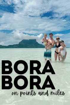 three people standing in shallow water with the text bora bora on points and miles above them