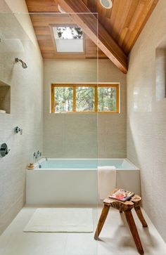 a bathroom with a large tub and wooden ceiling