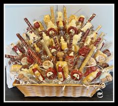 a basket filled with lots of different types of hot dogs and pretzels in it