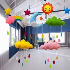 a room filled with lots of colorful clouds and stars hanging from it's ceiling