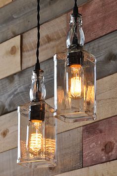 two lights hanging from a wooden wall with wood planks in the backround