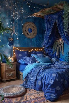 a bed with blue sheets and pillows in a room decorated with lights, plants and decorations